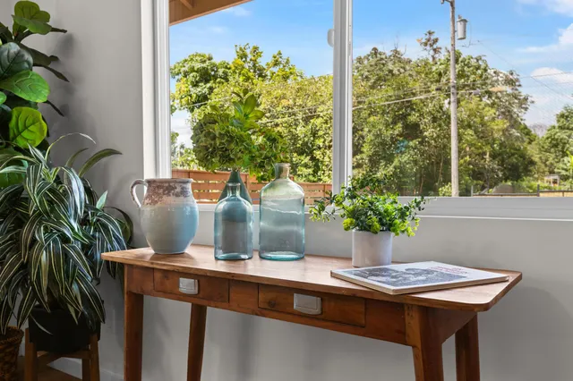 a table with chairs and potted plant on it