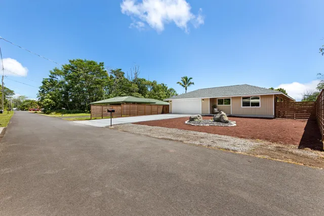 a front view of a house with a yard and a garage