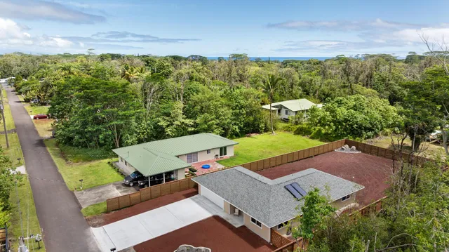 an aerial view of a house with a yard