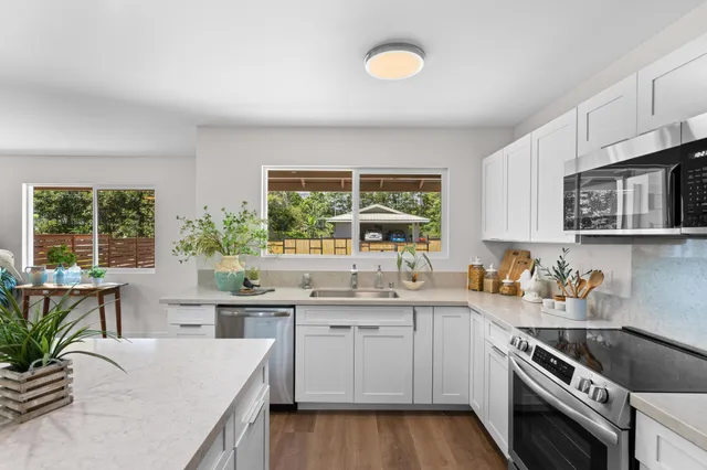 a kitchen with a sink stove and cabinets