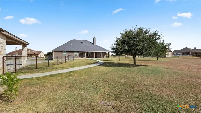 a view of yard with swimming pool and trees