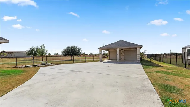 a view of a house with a yard and a garden