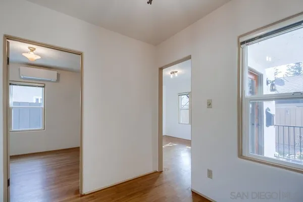 an empty room with windows and closet