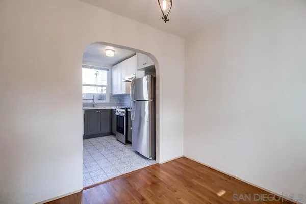a kitchen with a stove a refrigerator and cabinets
