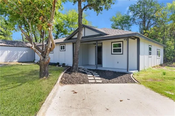 a front view of house with yard and trees
