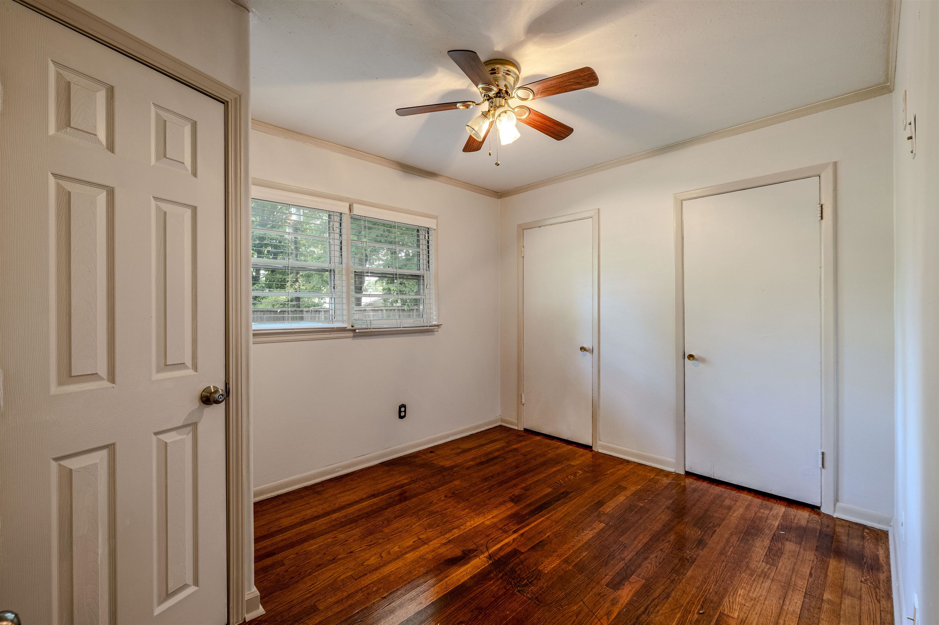 3953 Comanche Road Memphis, TN 38118 - Photo 16 of 24 Unfurnished bedroom featuring ornamental molding, dark wood-type flooring, and ceiling fan