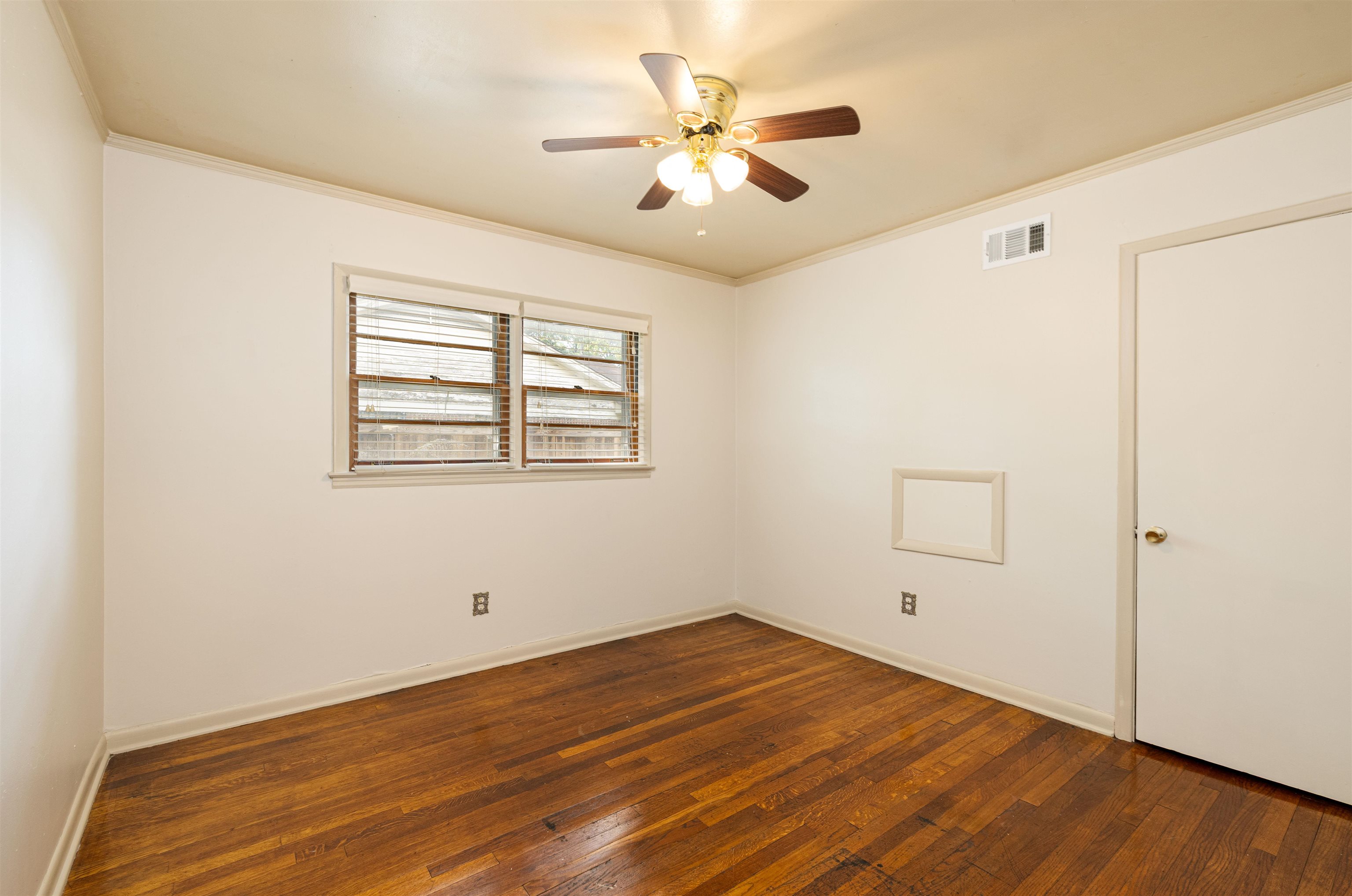 3953 Comanche Road Memphis, TN 38118 - Photo 17 of 24 Spare room featuring hardwood / wood-style flooring, a ceiling fan, and ornamental molding