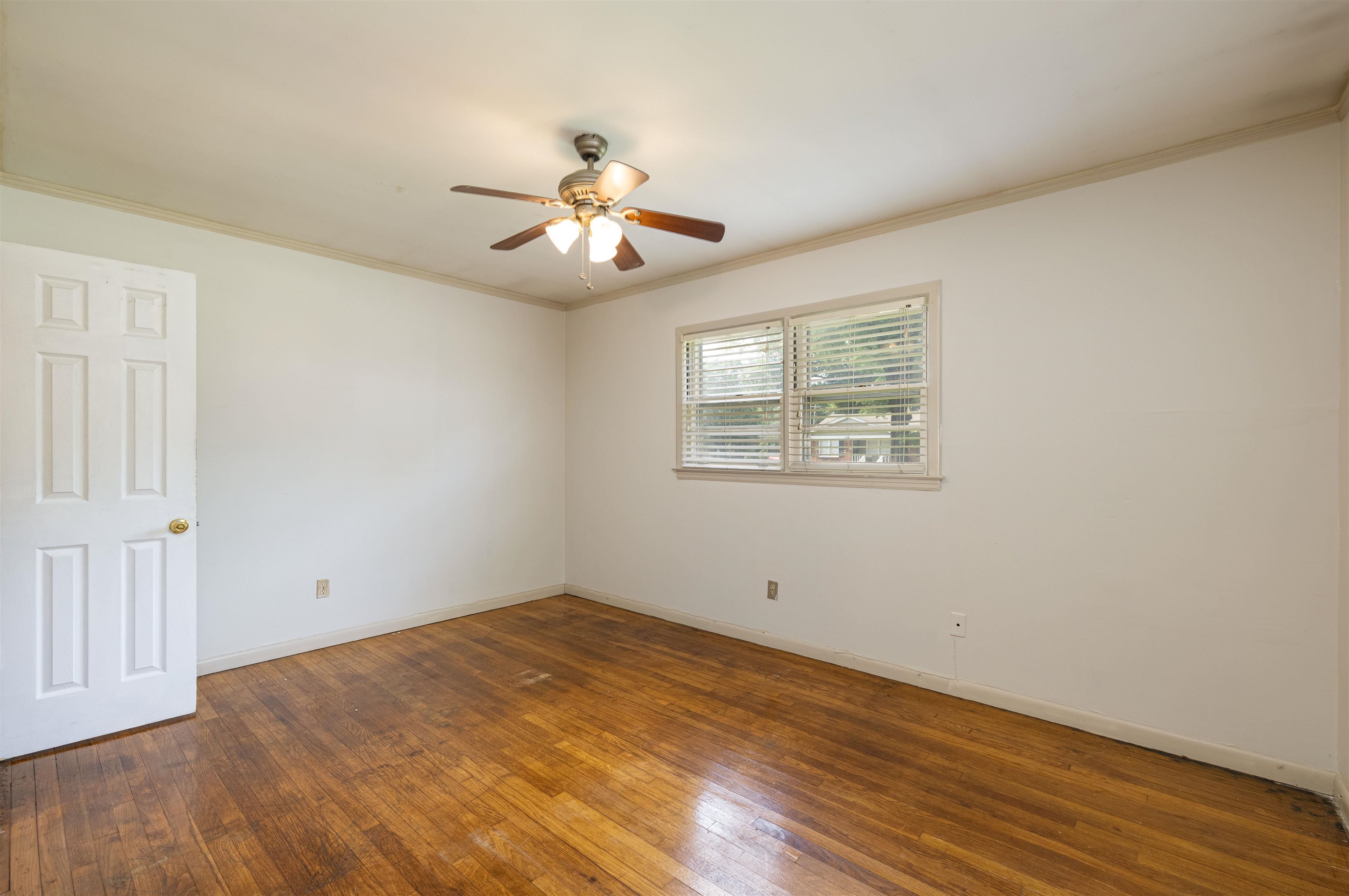 3953 Comanche Road Memphis, TN 38118 - Photo 18 of 24 Empty room with ceiling fan, wood-type flooring, and ornamental molding