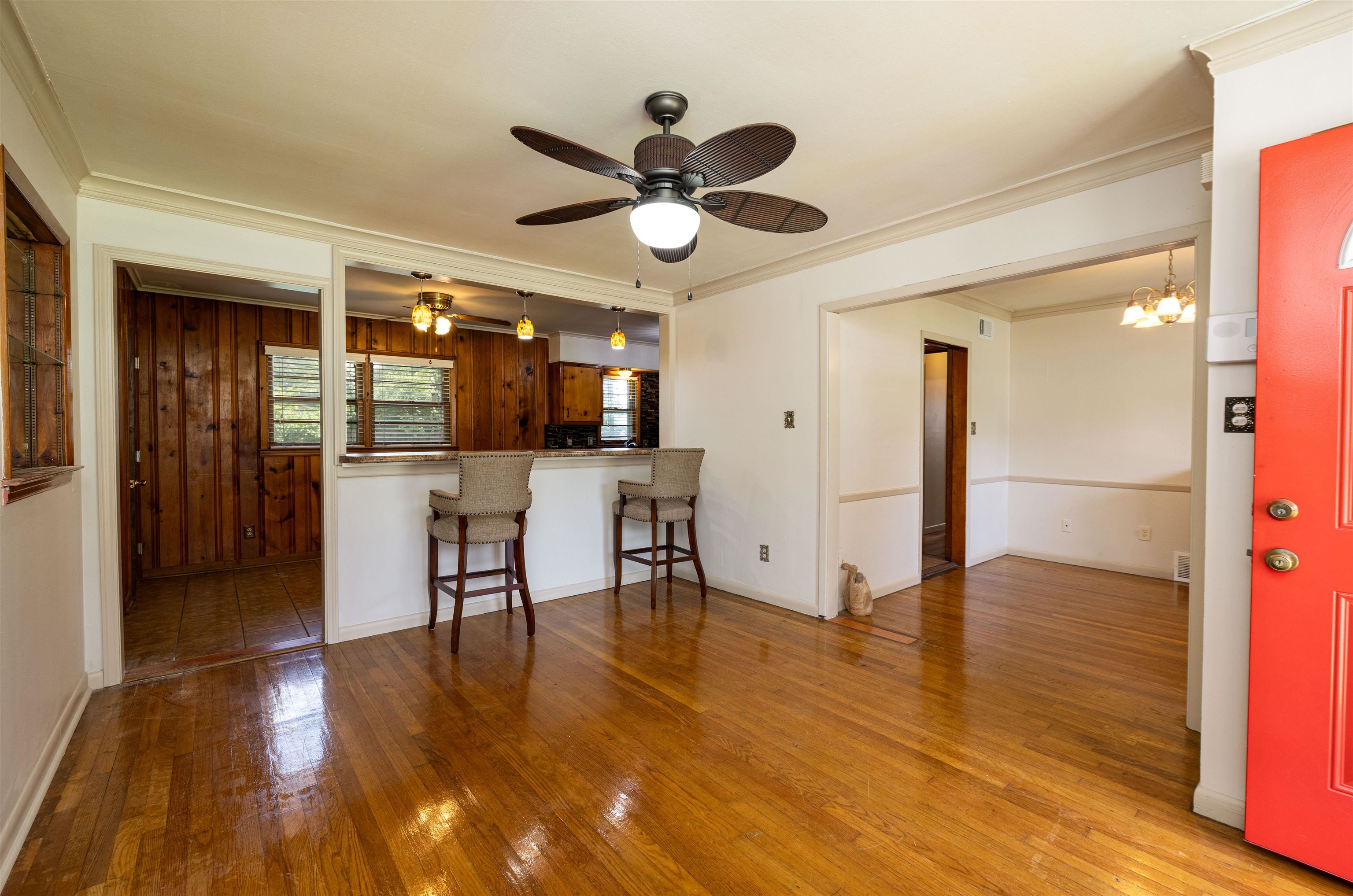 3953 Comanche Road Memphis, TN 38118 - Photo 22 of 24 Kitchen with wood-type flooring, ornamental molding, ceiling fan, a breakfast bar area, and a chandelier