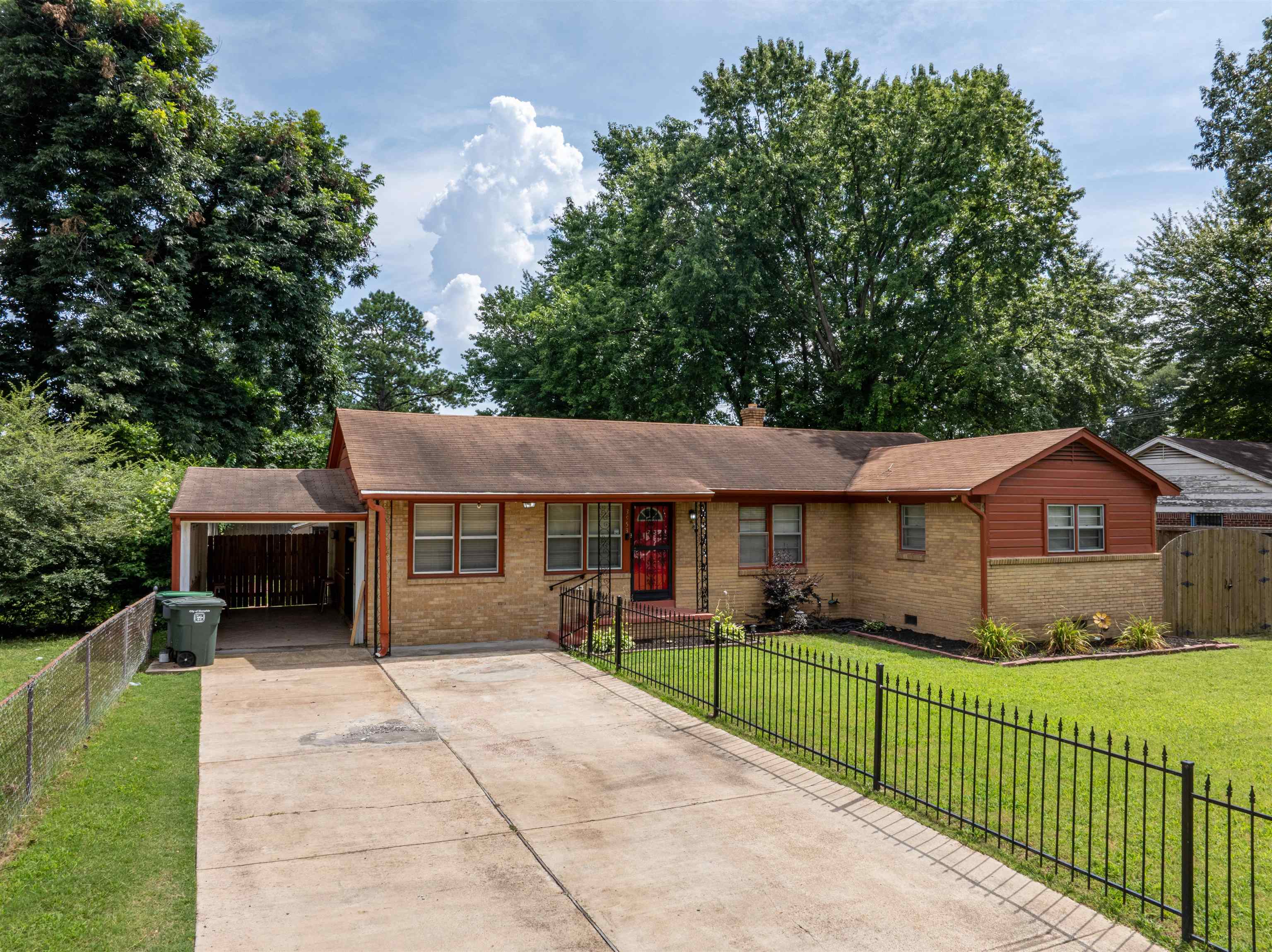 3953 Comanche Road Memphis, TN 38118 - Photo 3 of 24 Single story home featuring brick siding, concrete driveway, a carport, and roof with shingles