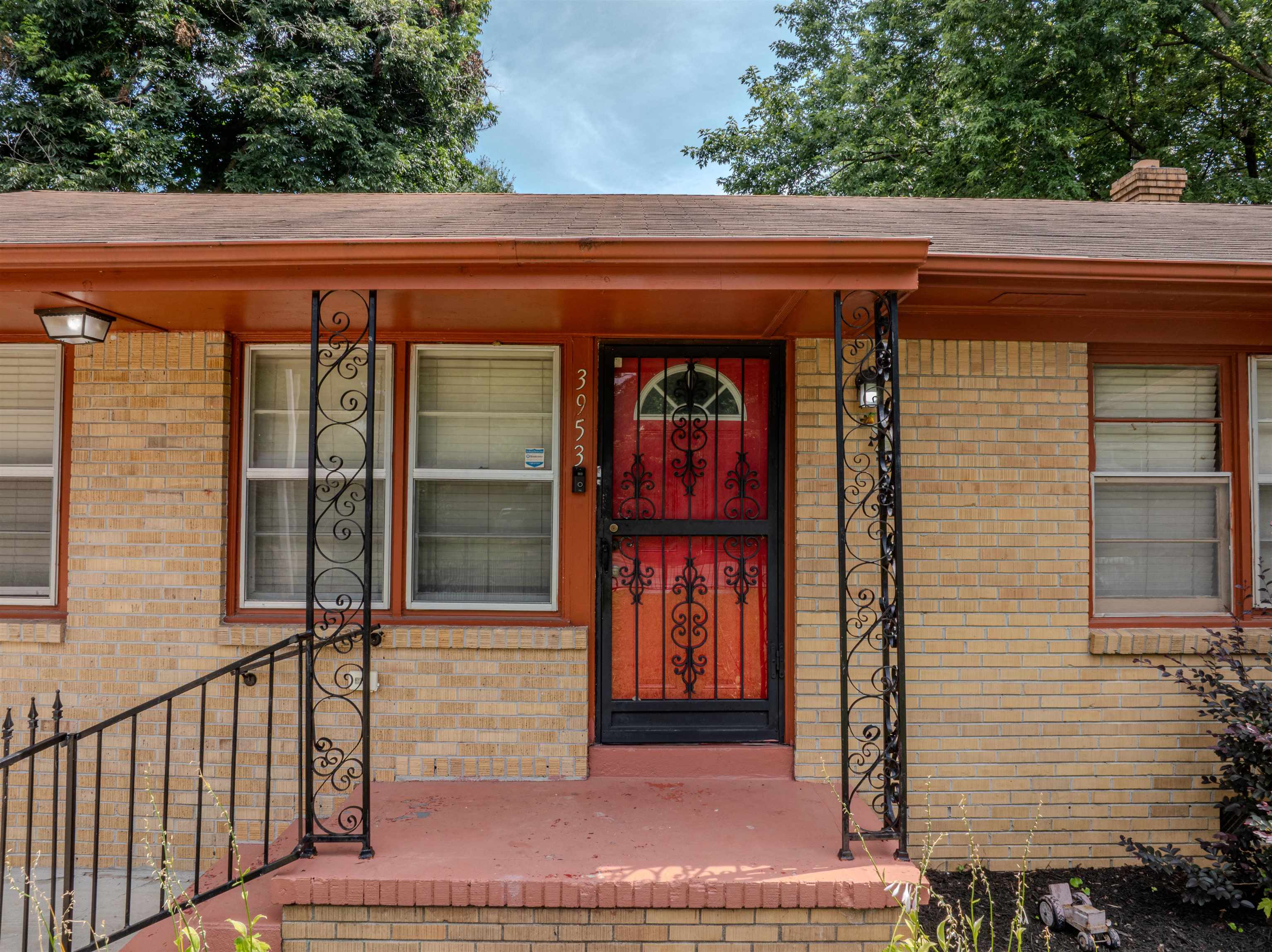 3953 Comanche Road Memphis, TN 38118 - Photo 4 of 24 View of exterior entry with brick siding, roof with shingles, a chimney, and covered porch