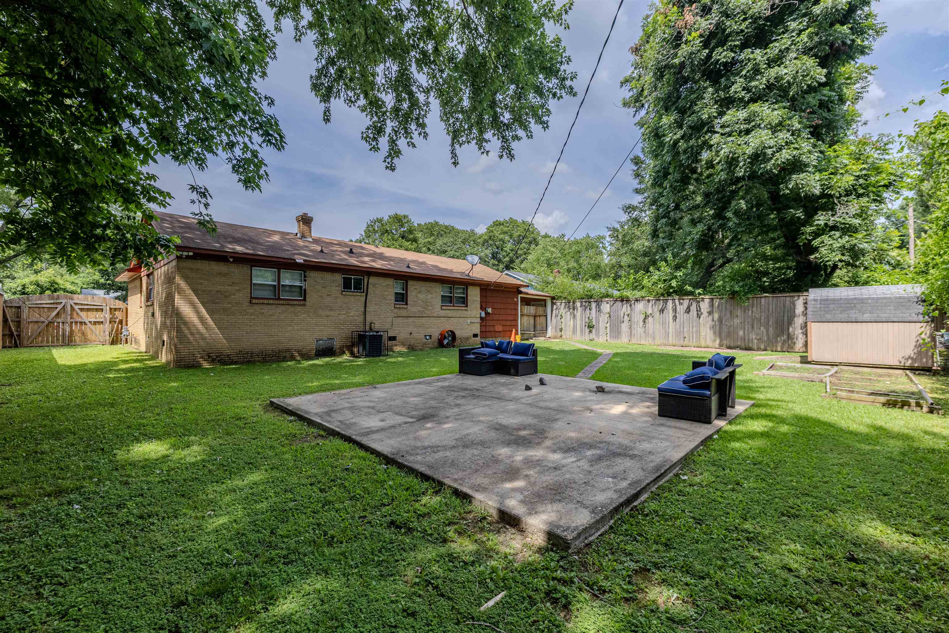 3953 Comanche Road Memphis, TN 38118 - Photo 6 of 24 Fenced backyard with a patio area and a shed