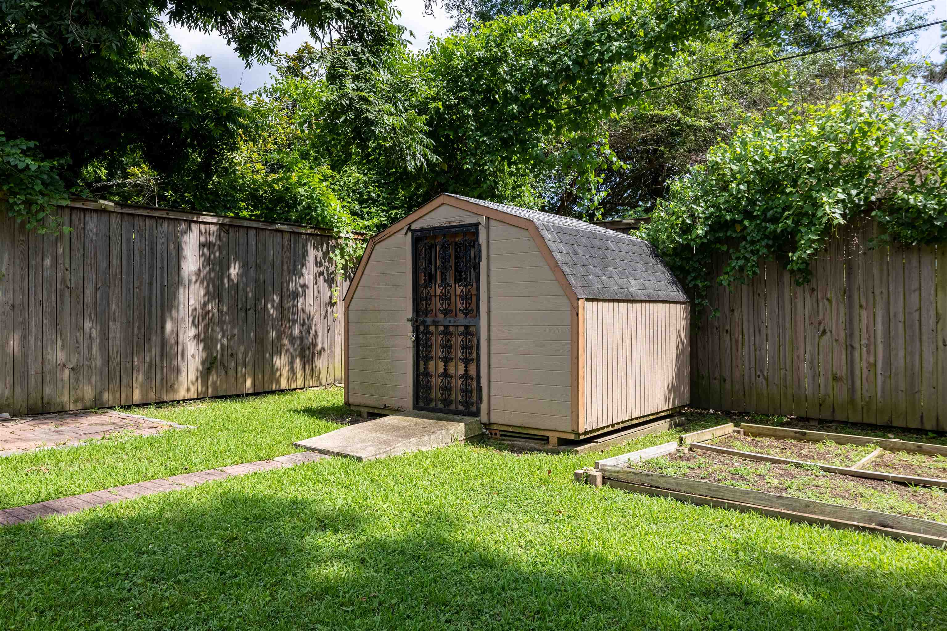 3953 Comanche Road Memphis, TN 38118 - Photo 7 of 24 View of shed featuring a garden and a fenced backyard