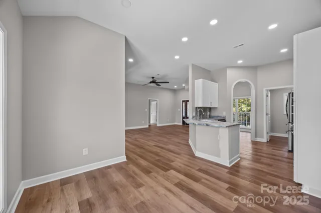 a open kitchen with white cabinets and stainless steel appliances