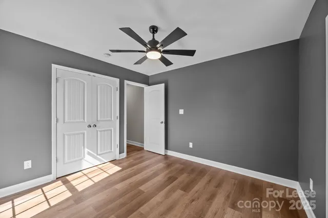 a view of a big room with wooden floor and windows in a room