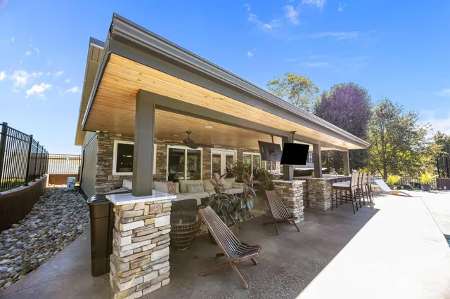 a living room with patio furniture and garden