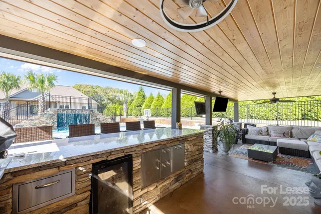 a living room with patio furniture and a potted plants