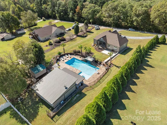 a view of a swimming pool with lawn chairs