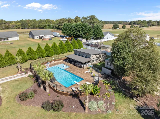 an aerial view of a house with a lake view