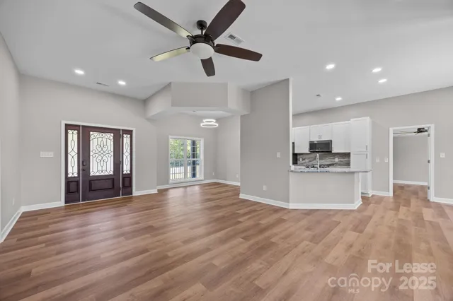 a view of kitchen with sink and wooden floor