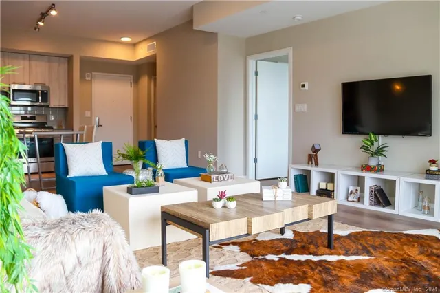 a living room with furniture and a flat screen tv