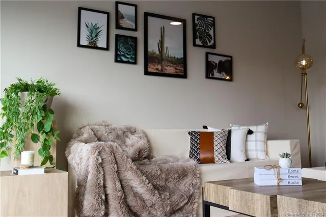 a bed room with furniture and painting on the wall