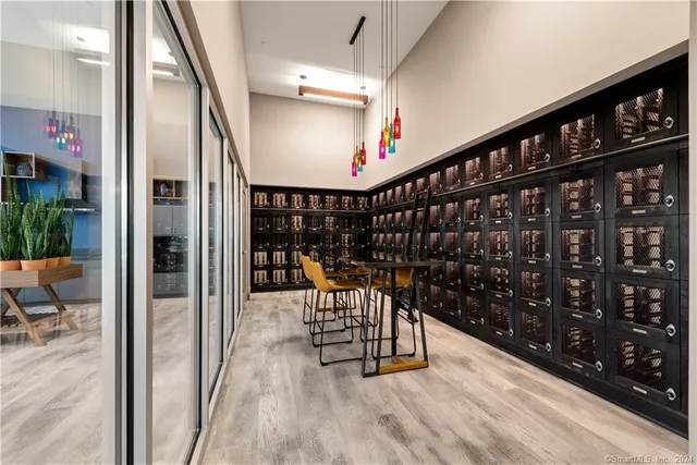a view of a hallway with chairs and potted plants