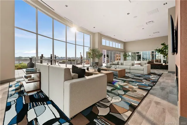 a living room with furniture city view and large windows