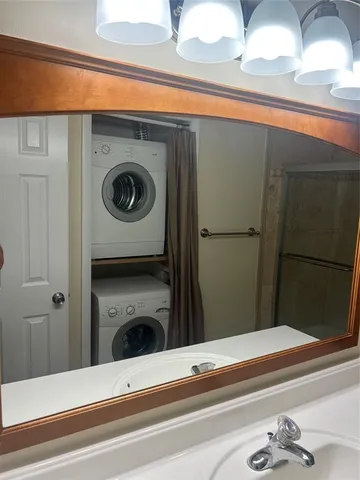 an empty room with windows and ceiling fan