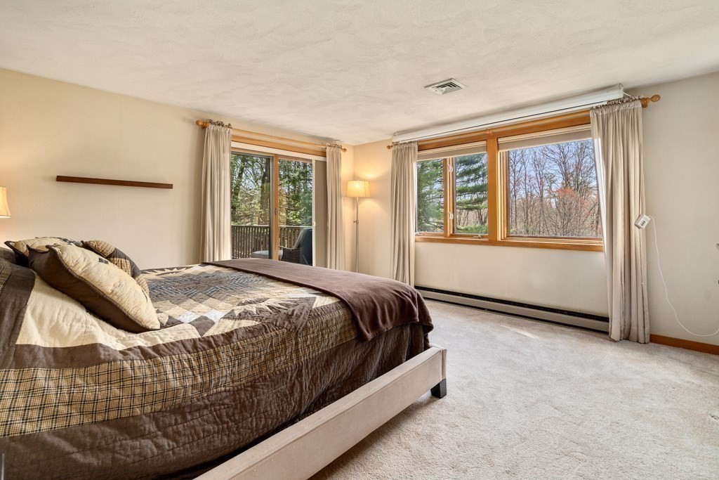 6 Crestwood Road North Reading, MA 01864 - Photo 11 of 36 a bedroom with a bed and wooden floor