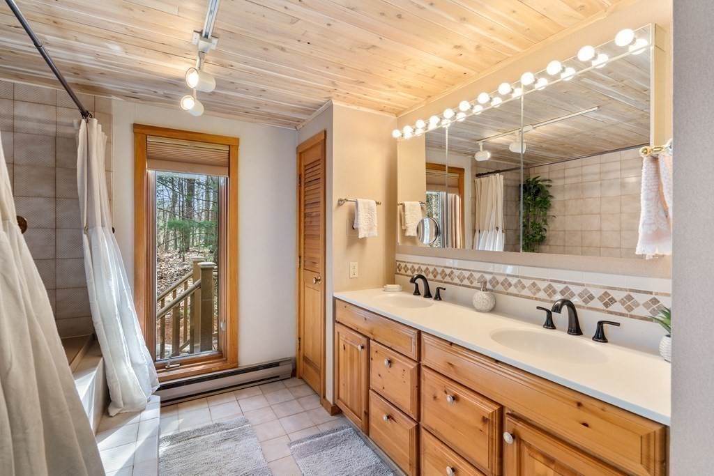 6 Crestwood Road North Reading, MA 01864 - Photo 13 of 36 a spacious bathroom with a double vanity sink and a mirror
