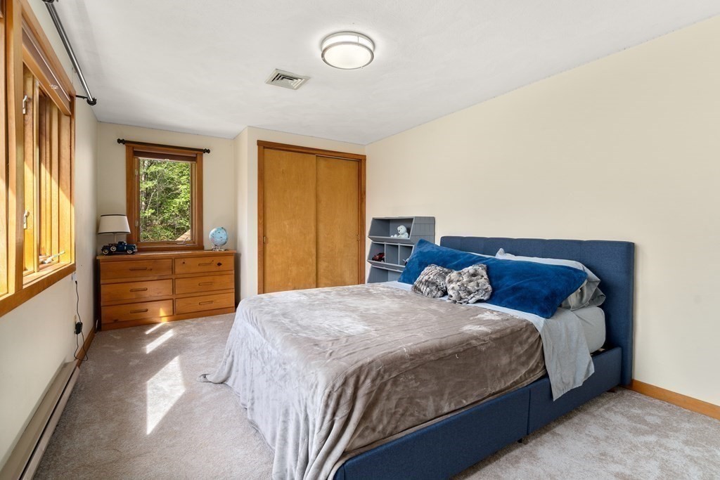 6 Crestwood Road North Reading, MA 01864 - Photo 18 of 36 a bedroom with a bed and a dresser next to a window