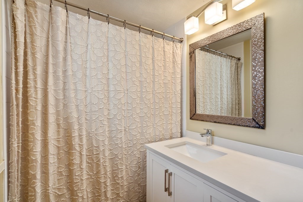 6 Crestwood Road North Reading, MA 01864 - Photo 19 of 36 a bathroom with a sink and a mirror
