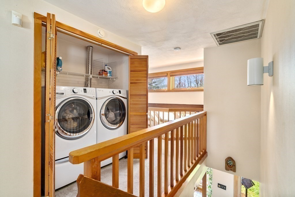 6 Crestwood Road North Reading, MA 01864 - Photo 20 of 36 a view of a hallway with washer and dryer