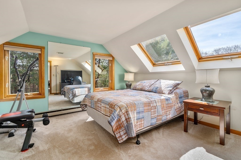 6 Crestwood Road North Reading, MA 01864 - Photo 21 of 36 a spacious bedroom with a bed and a chandelier