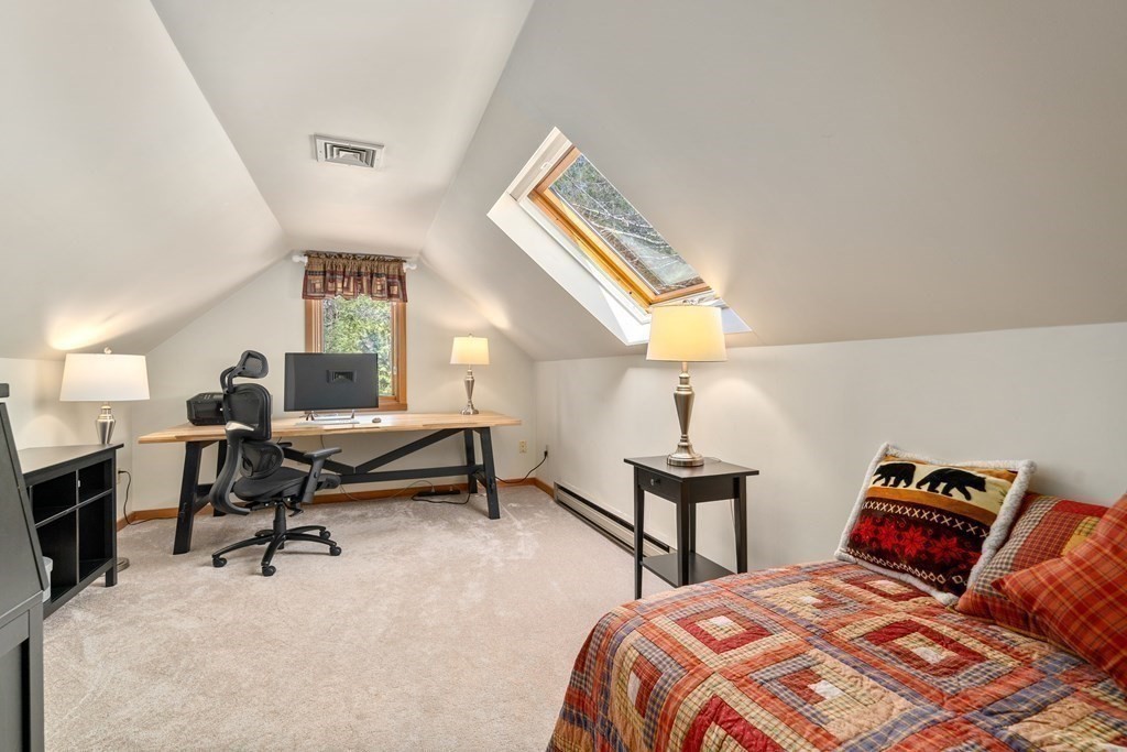 6 Crestwood Road North Reading, MA 01864 - Photo 23 of 36 a bedroom with a bed and a chandelier