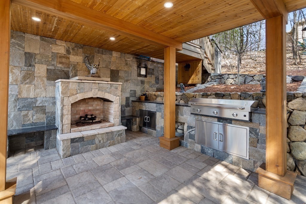 6 Crestwood Road North Reading, MA 01864 - Photo 26 of 36 a living room with stainless steel appliances furniture a fireplace and a flat screen tv