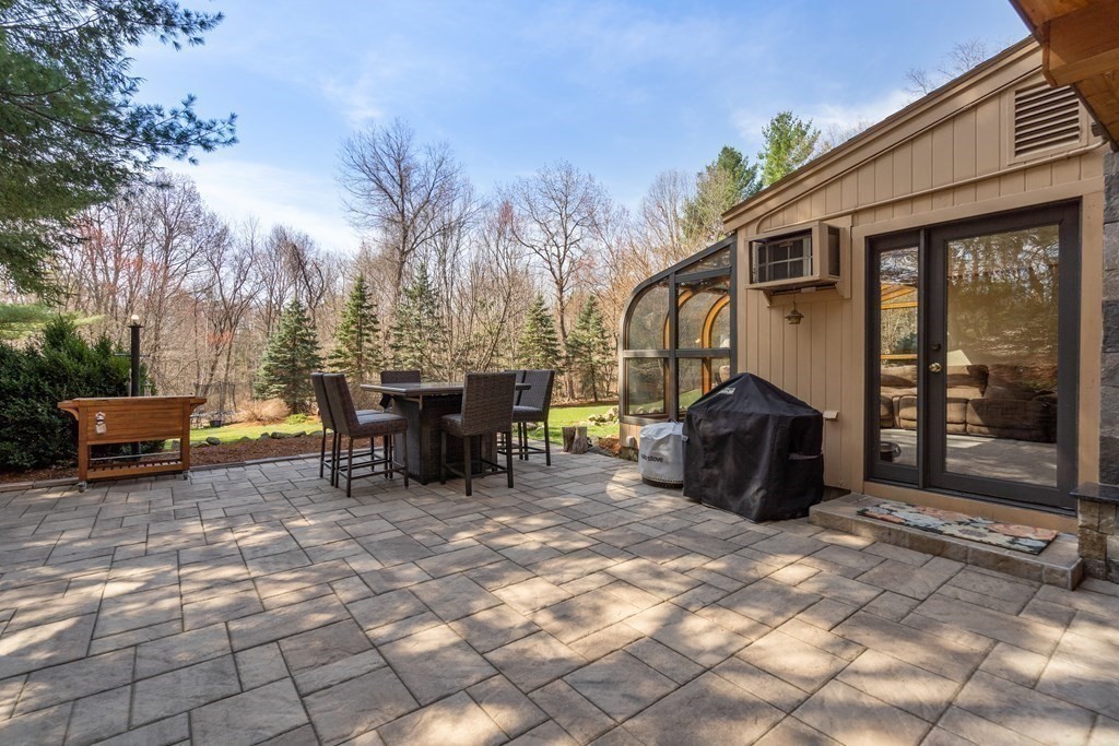 6 Crestwood Road North Reading, MA 01864 - Photo 27 of 36 a view of a patio with a table and chairs under an umbrella