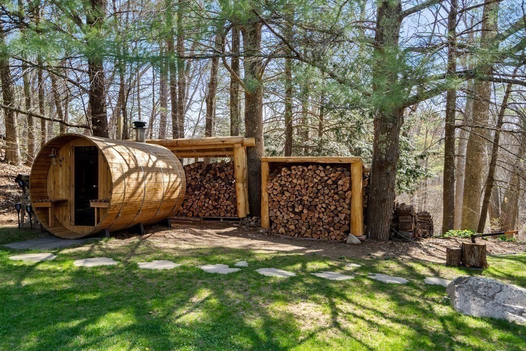 6 Crestwood Road North Reading, MA 01864 - Photo 29 of 36 a view of a backyard with large trees and wooden fence