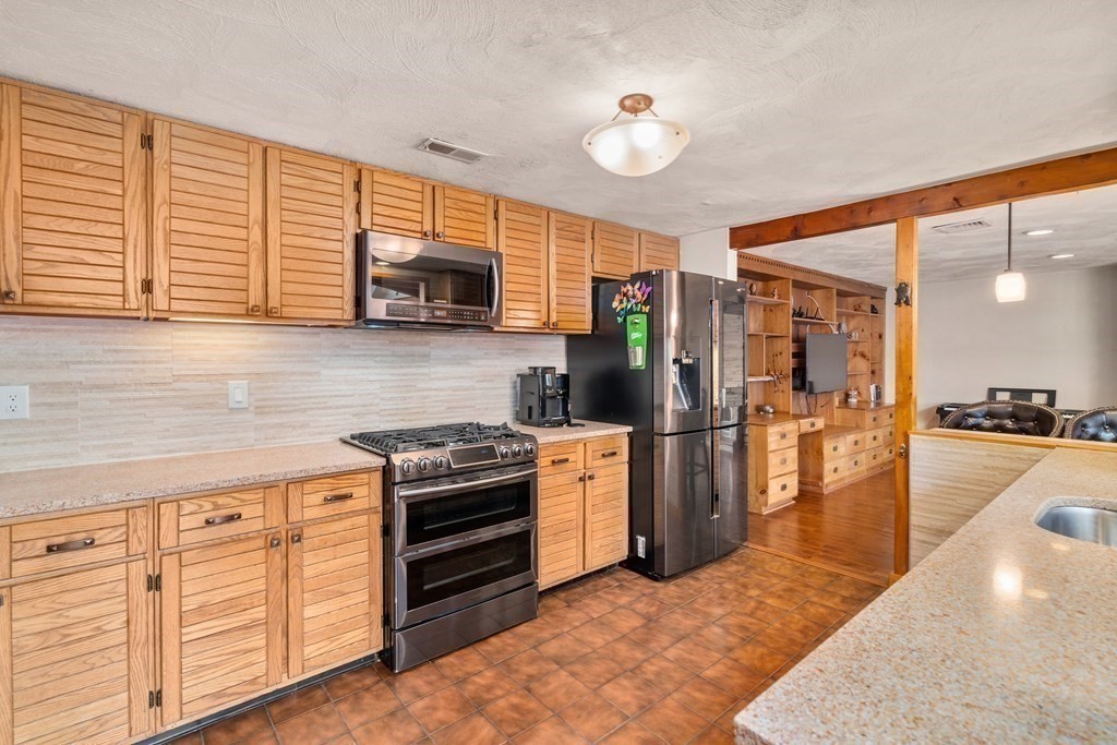 6 Crestwood Road North Reading, MA 01864 - Photo 6 of 36 a kitchen with stainless steel appliances granite countertop a stove a sink and a refrigerator