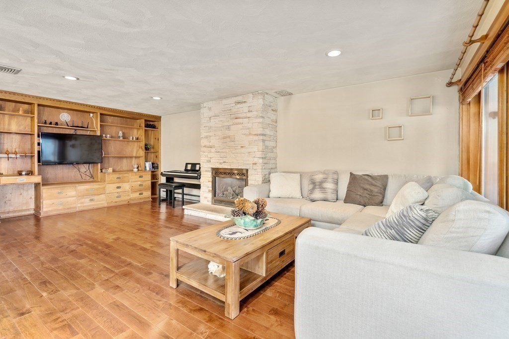 6 Crestwood Road North Reading, MA 01864 - Photo 9 of 36 a living room with fireplace furniture and a flat screen tv