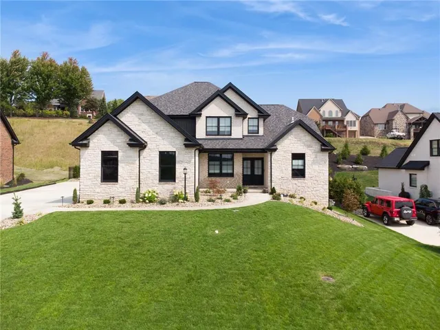 a front view of a house with a garden and porch