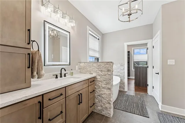 a bathroom with a sink a mirror and a shower