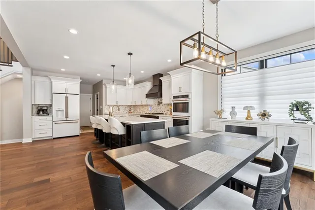 a large kitchen with a table and chairs