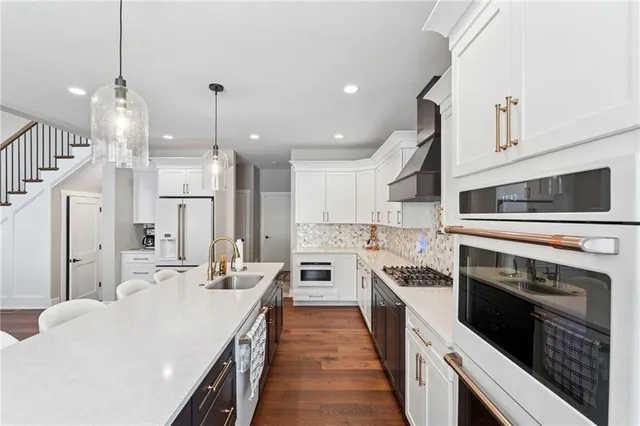 a kitchen with stainless steel appliances and white cabinets
