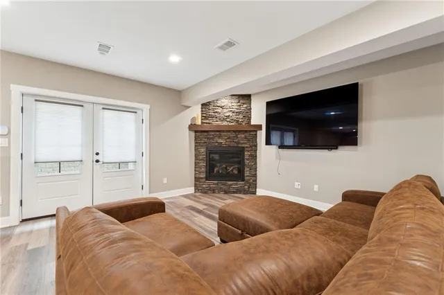 a living room with couches and a flat screen tv