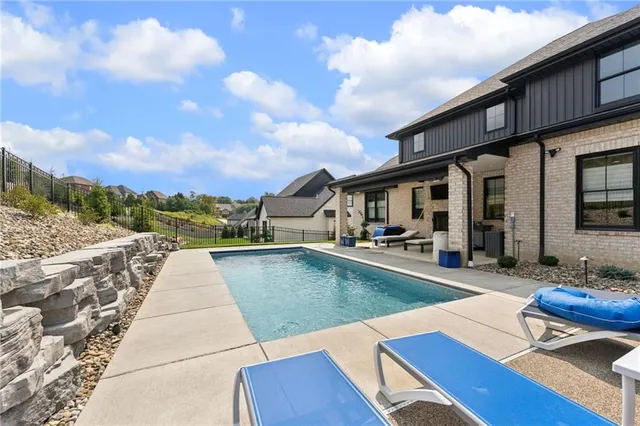 a view of a patio with swimming pool table and chairs