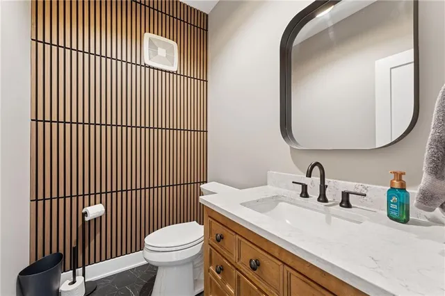 a bathroom with a sink a toilet and mirror