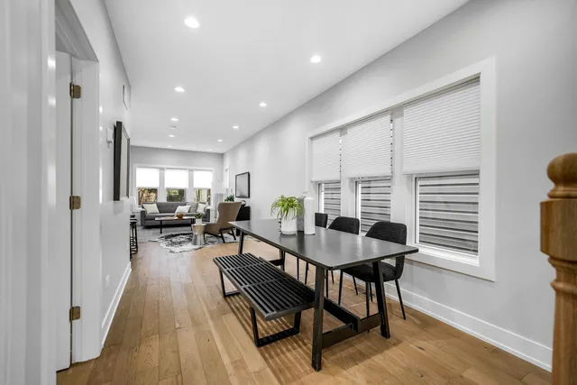 a view of a a dining room with furniture window and wooden floor