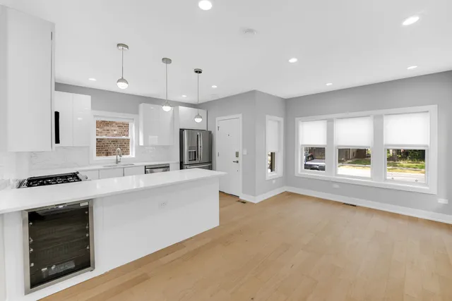 a large white kitchen with a large window